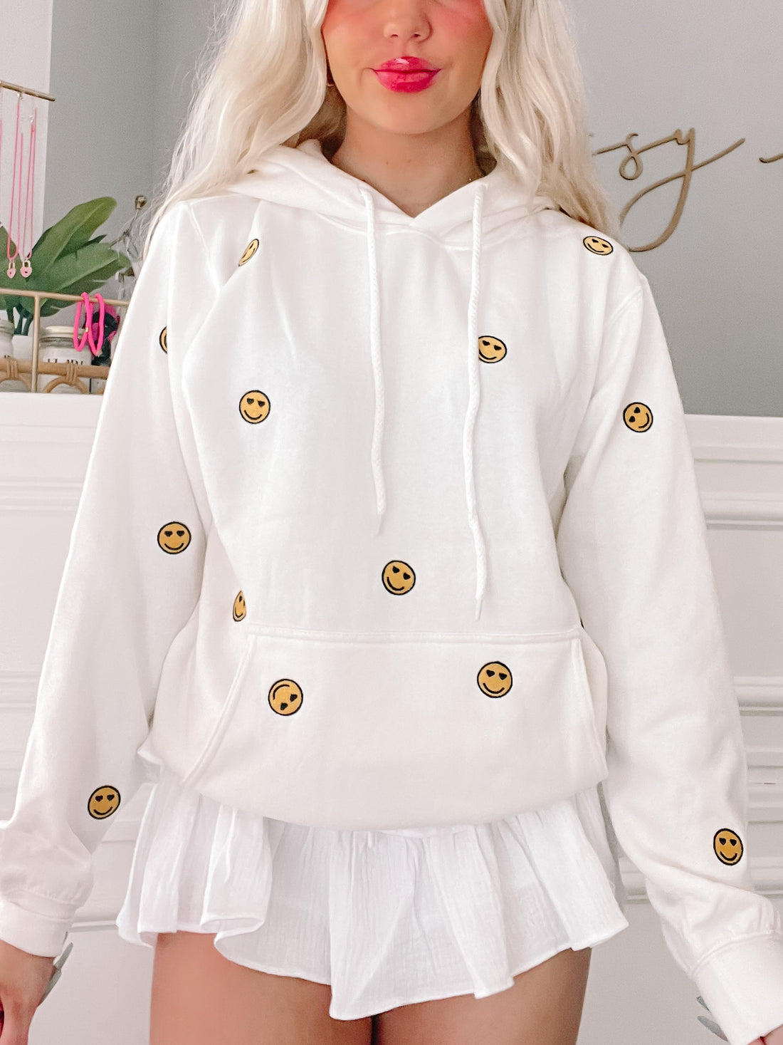 White Happy Hearts Hoodie with embroidered smiley faces.
