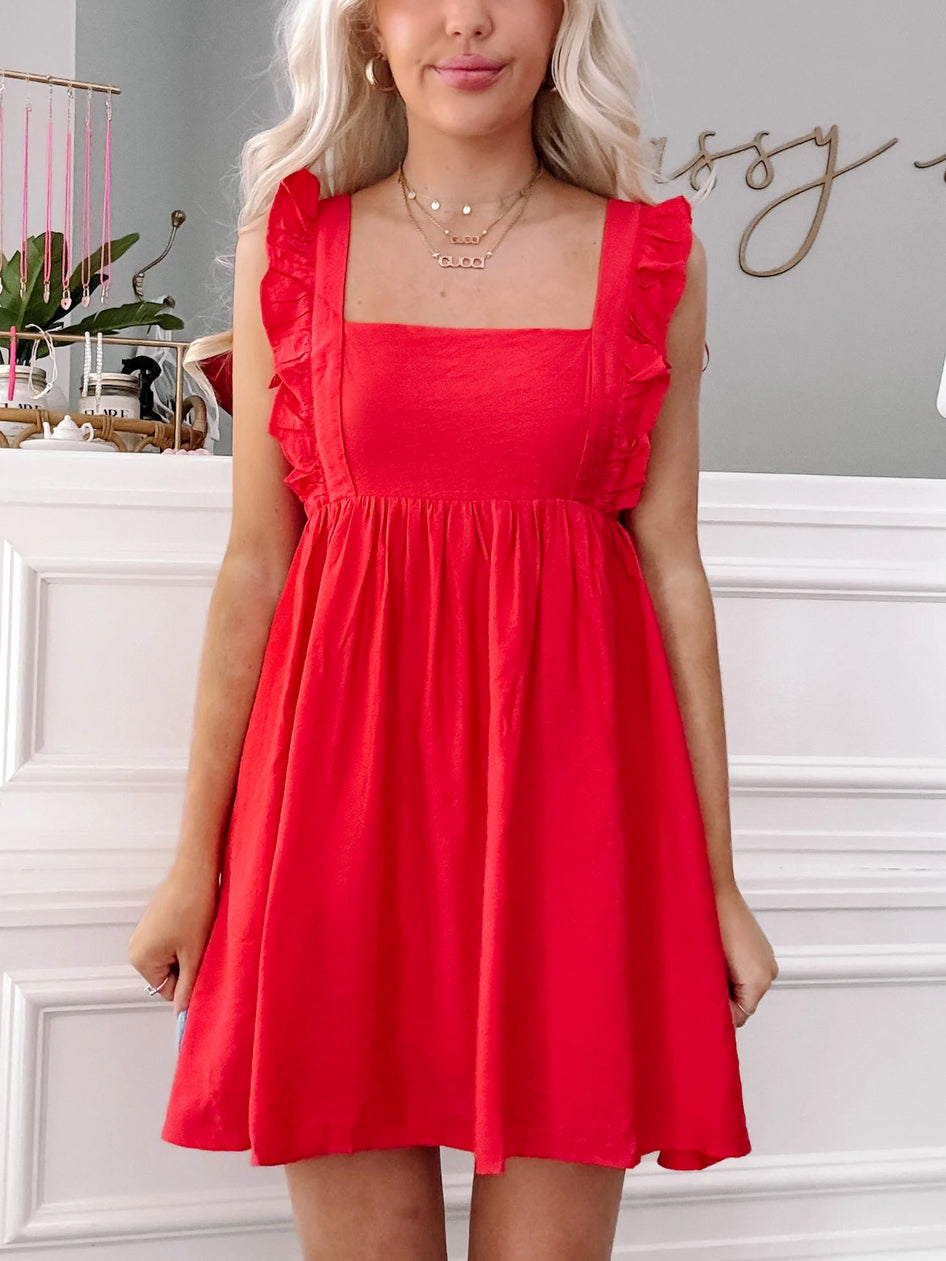Red Ruby Ruffles mini dress with square neck and ruffle detailing.
