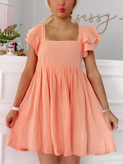 Peach Blissfully Orange dress with ruffled short sleeves and square neckline.

