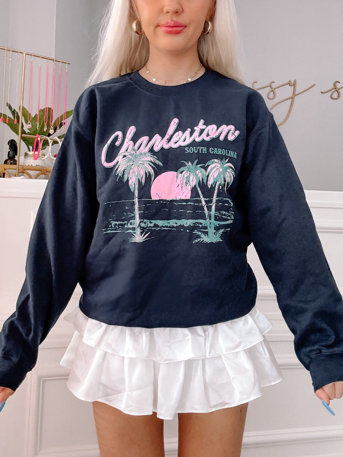 Charleston Crewneck navy sweatshirt featuring palm tree and sunset graphic.
