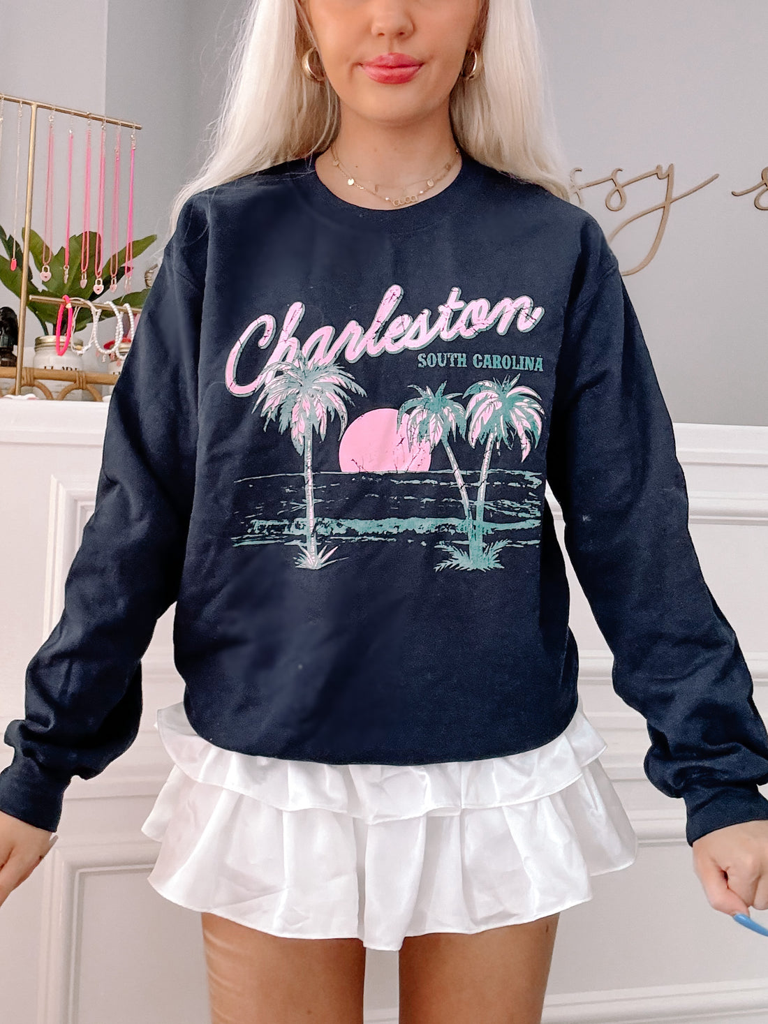 Navy blue crewneck sweatshirt featuring a palm tree and sunset graphic, "Charleston, South Carolina" text.

