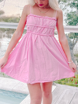 Pink summer dress, ruched bodice, A-line skirt, perfect for summer events.

