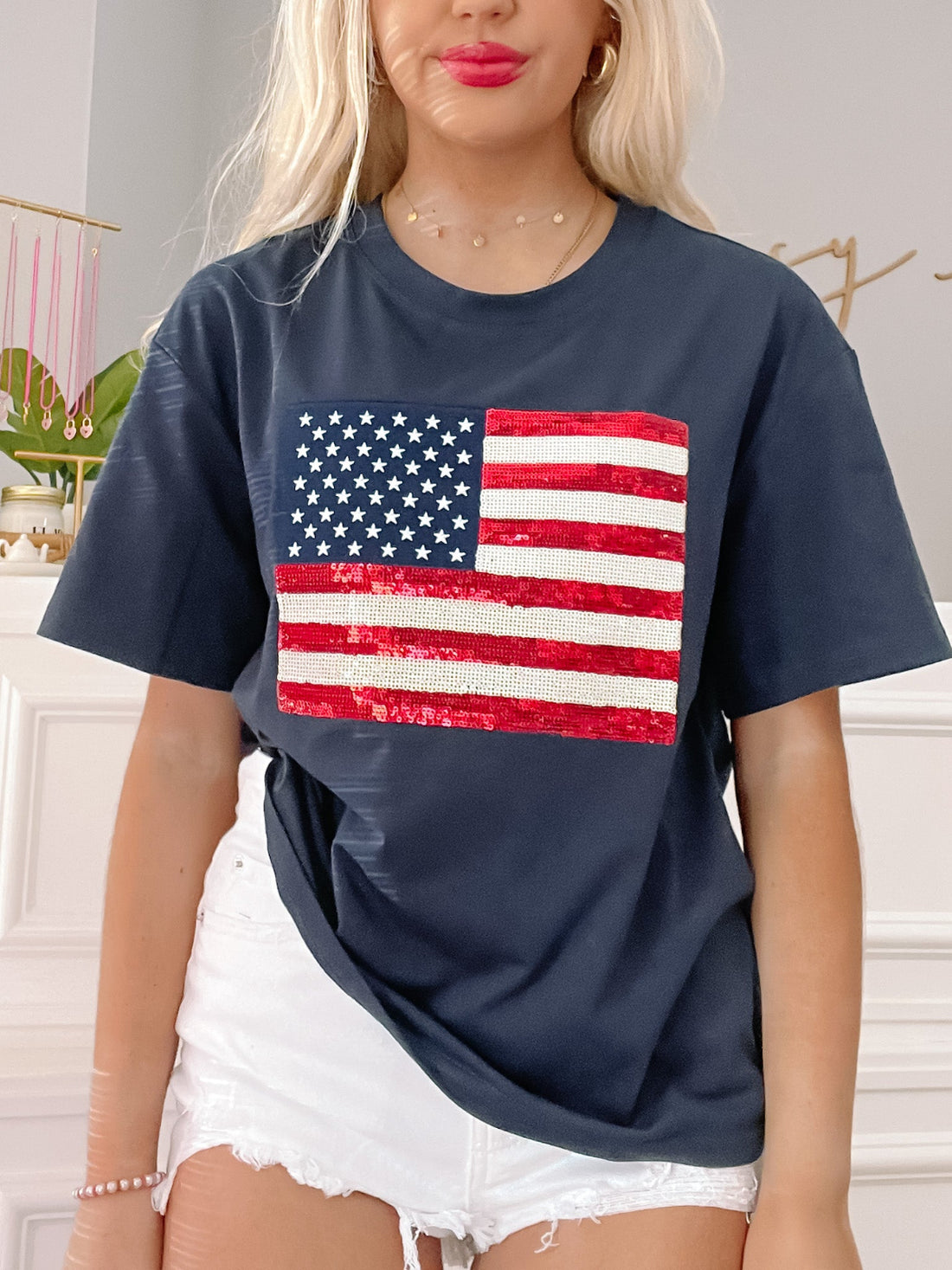 Blue Born in the USA Tee by Sassy Shortcake with red white and blue sequin American flag graphic on a navy blue oversized tee shirt.
