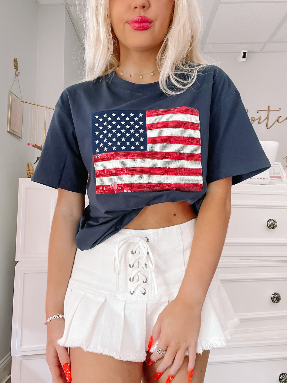 Sequin-embellished American flag graphic on a navy blue tee shirt
