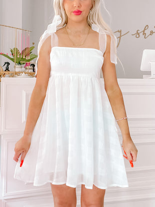 White eyelet mini dress with sheer ribbon straps
