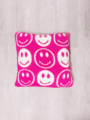 Smiley Dreams Pillow: Pink plush pillow with white smiley faces, perfect for kids.

