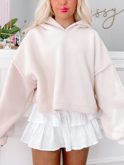 Cream-colored Bear Hug Pullover, oversized fit, soft fleece fabric.
