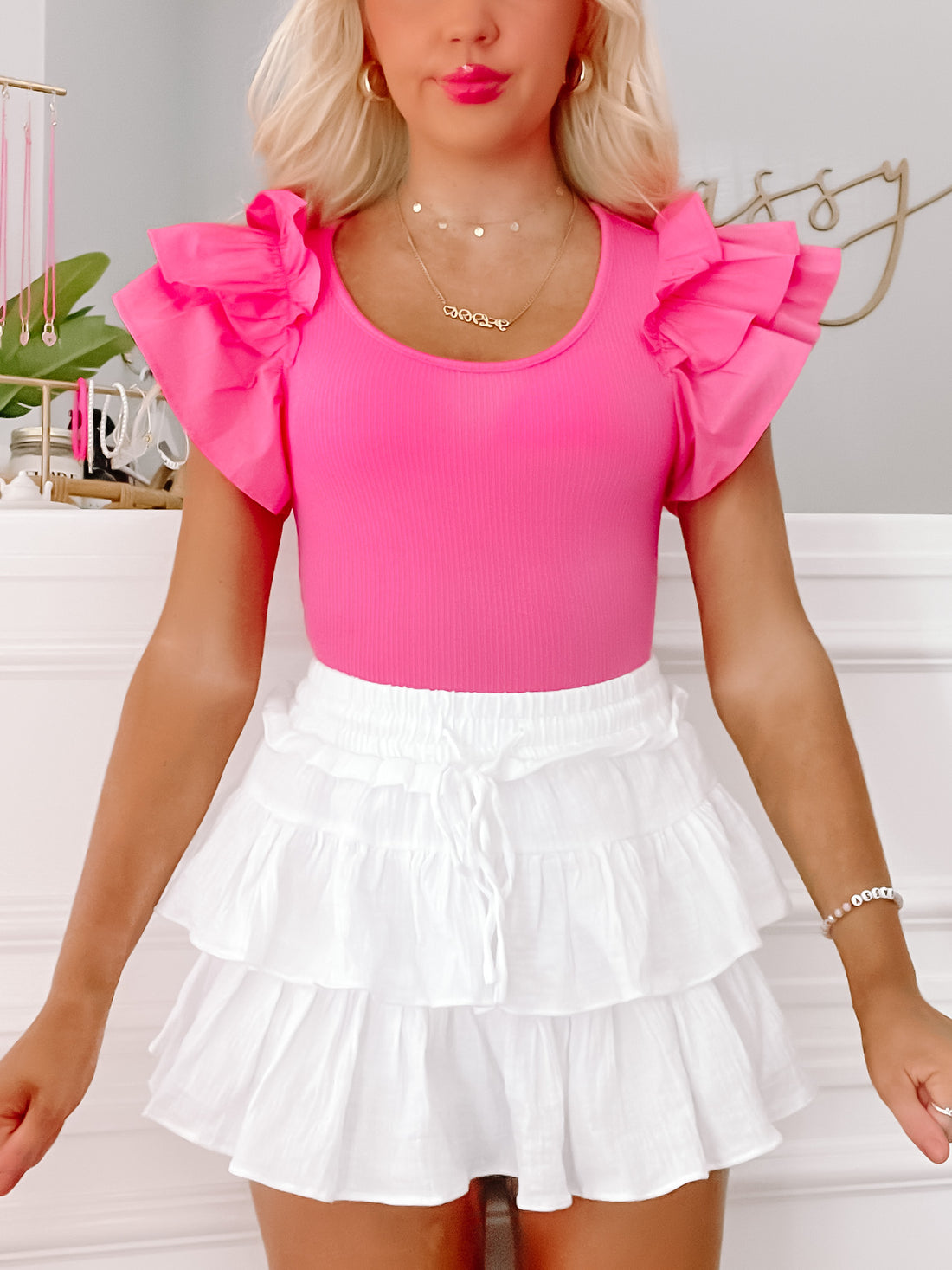 Hot pink ruffled bodysuit, short sleeves, ribbed fabric

