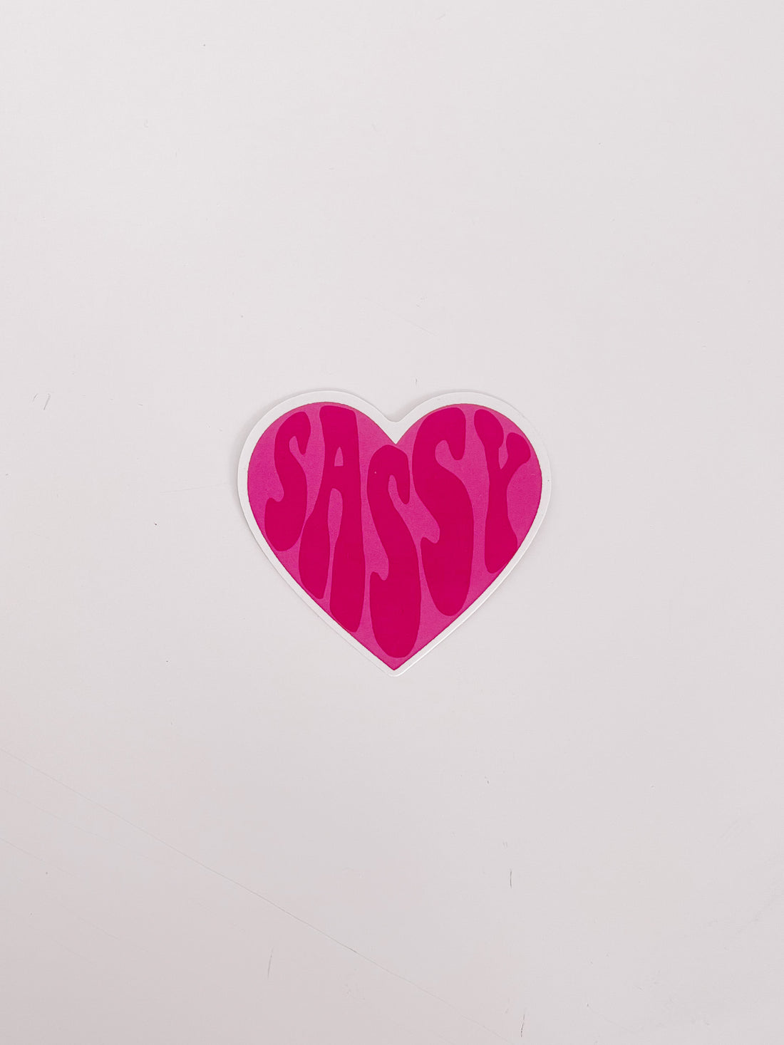 Pink heart-shaped sticker with "Sassy" in a retro font.
