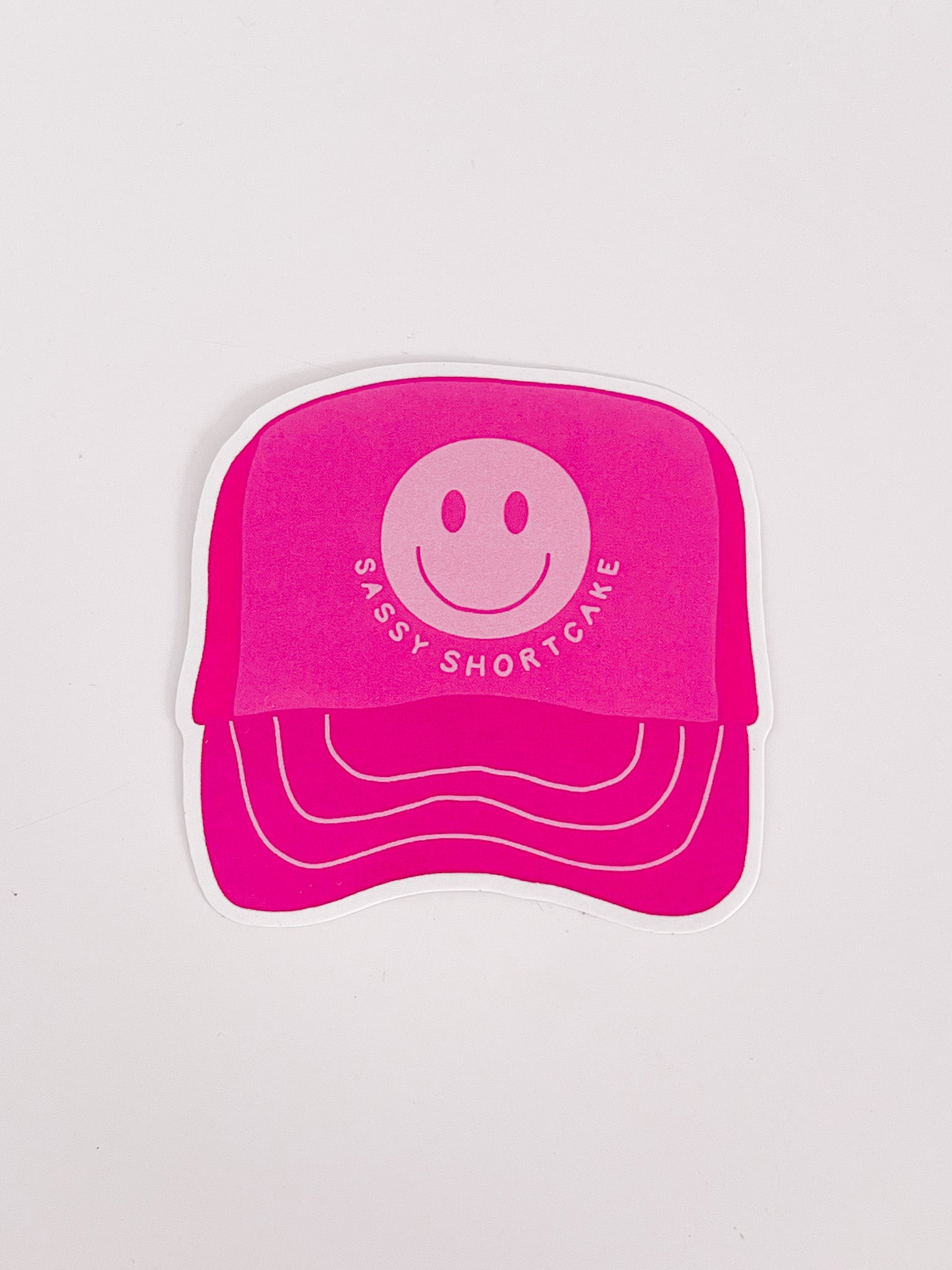 Pink trucker hat sticker with smiley face design
