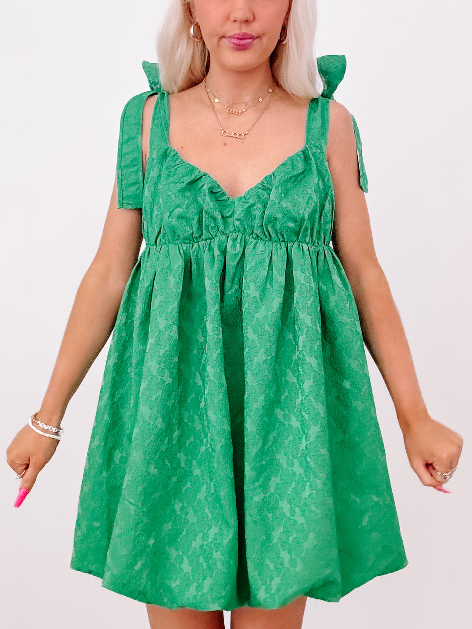 Emerald green floral Just My Luck dress with tie straps.

