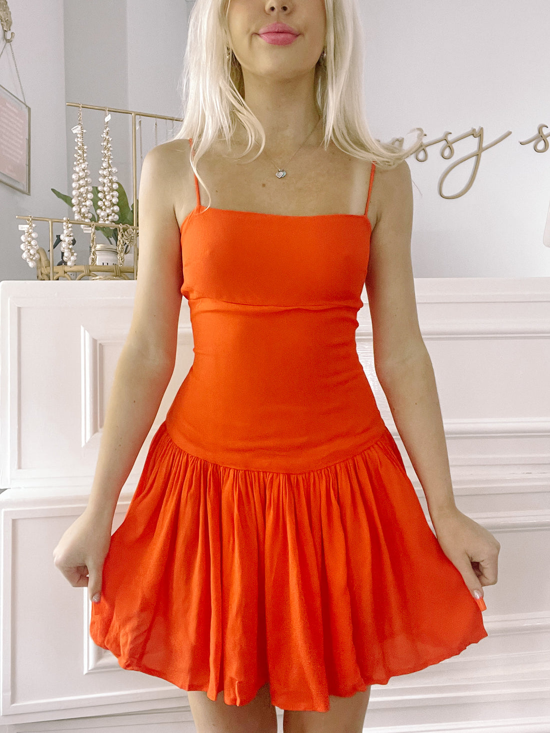Bright orange Slice n Dice mini dress with a fitted bodice and a tiered skirt.
