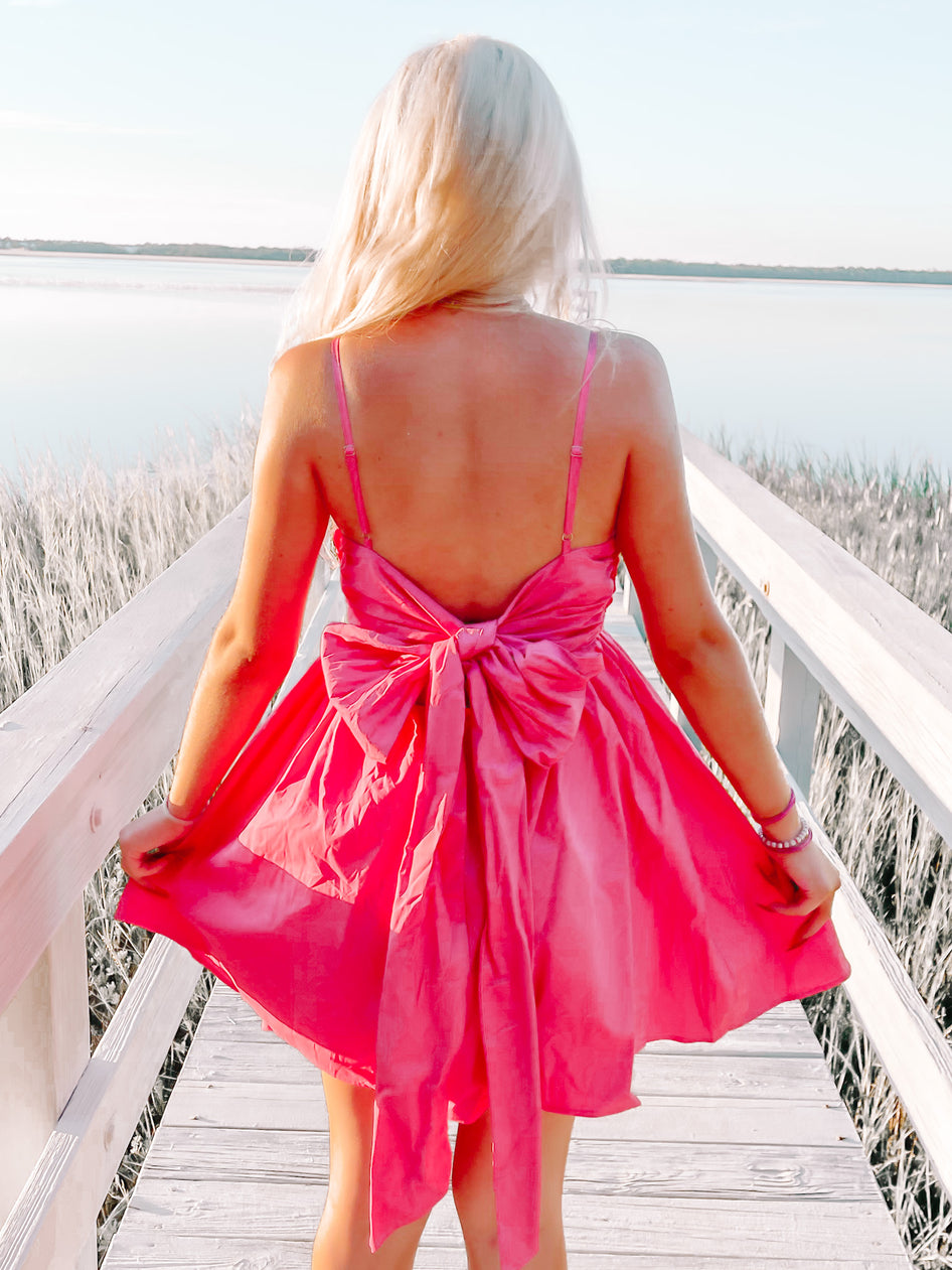 Pink Bow Tide dress with large bow detail in the back.
