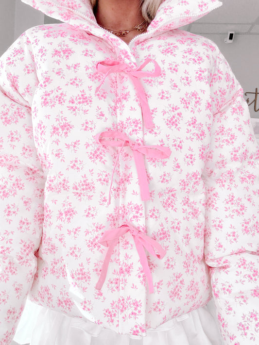 Pink floral puffer jacket with cute pink ribbon detailing.
