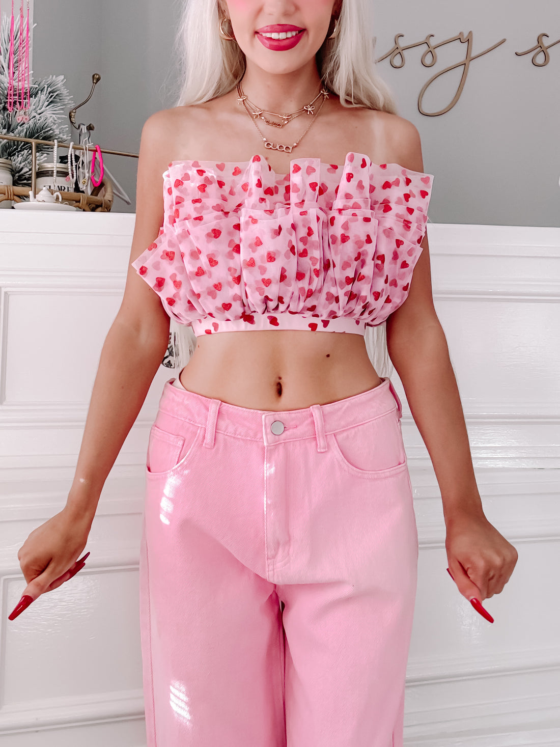 A light pink tulle tiered crop top with sparkly red hearts, lined with a hidden side zipper, model for Sassy Shortcake