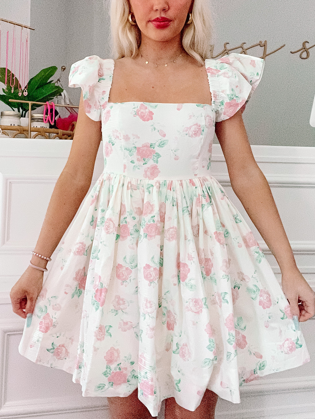 Floral skater dress in a pastel pink and green rose print.
