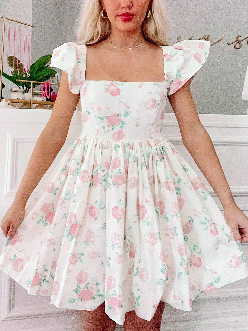 Floral Rosette dress with puff sleeves and a fit-and-flare silhouette.
