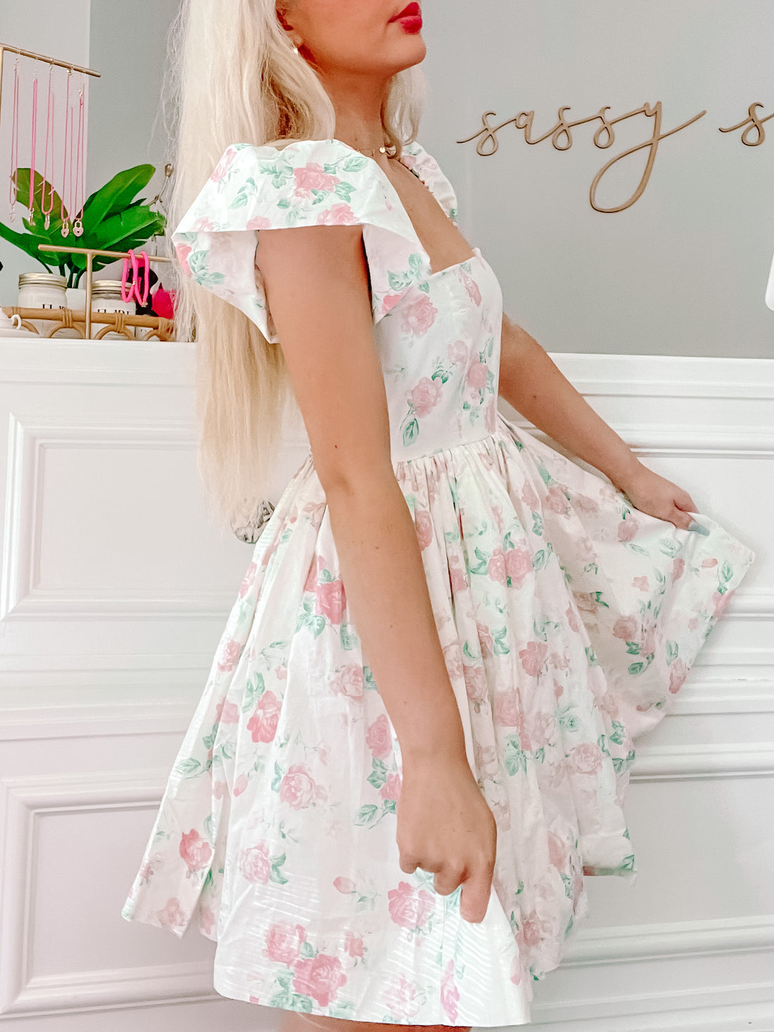 Floral mini dress with ruffled sleeves, shown on model against white background.
