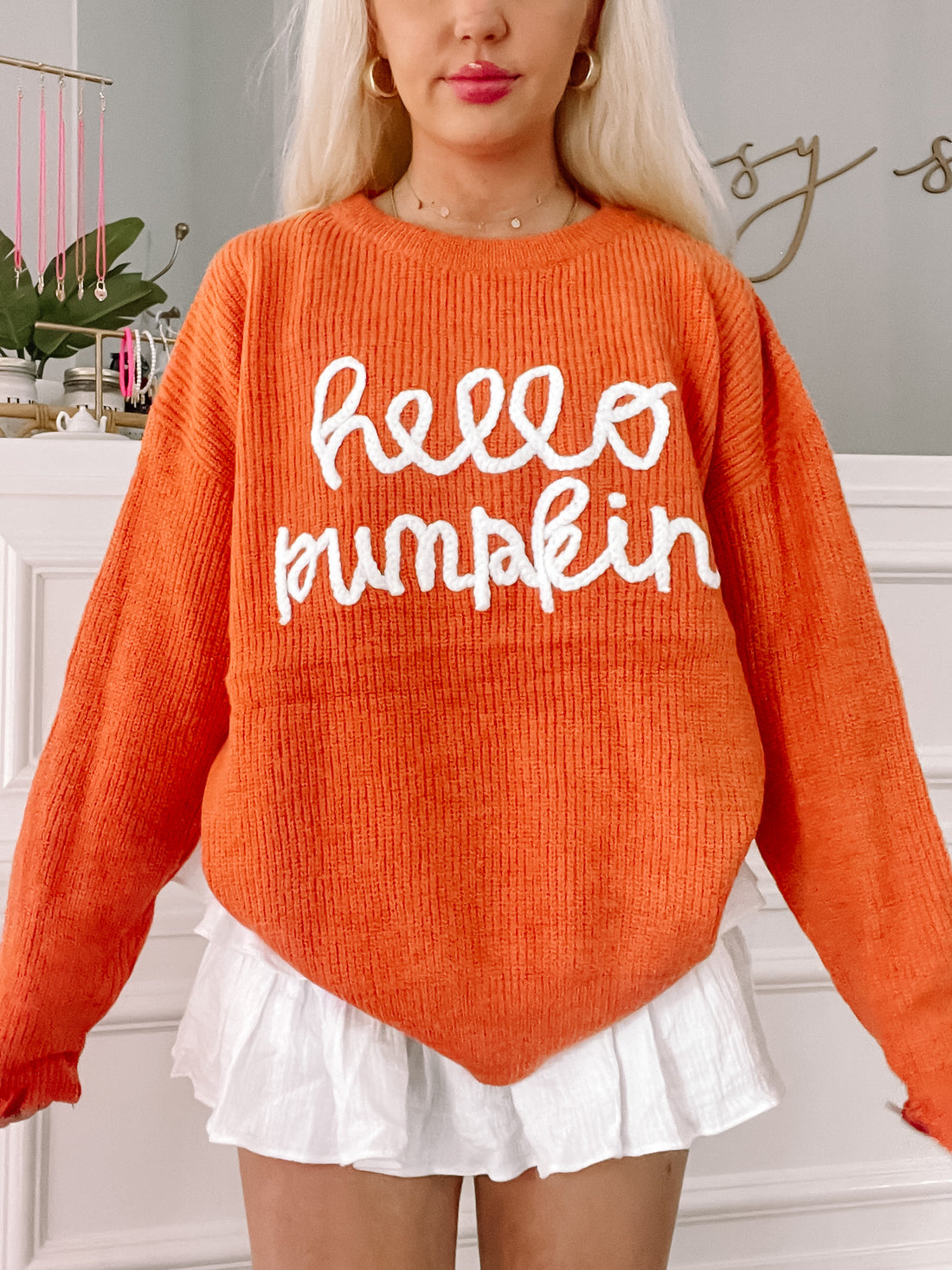 Orange Hello Pumpkin sweater with white embroidered lettering.
