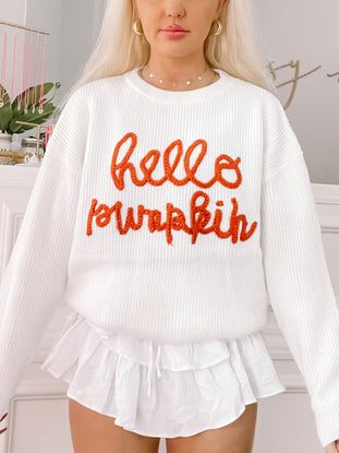 Cream Hello Pumpkin sweater with orange embroidered text
