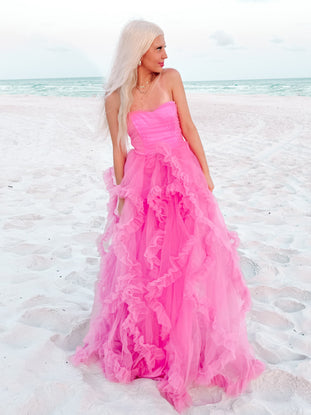 Pink tulle maxi dress with ruffled skirt, perfect for beach weddings or special occasions.

