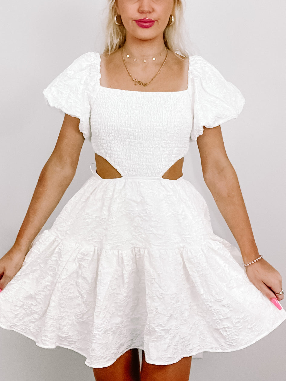 White Clementine Crush dress with puff sleeves and cutout detail.
