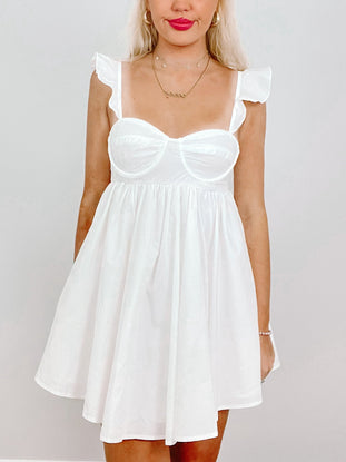 White cotton Wish Wish dress with ruffle straps and fitted bodice.
