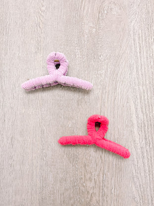 Fuzzy claw clips, pink and coral, soft velvet texture.
