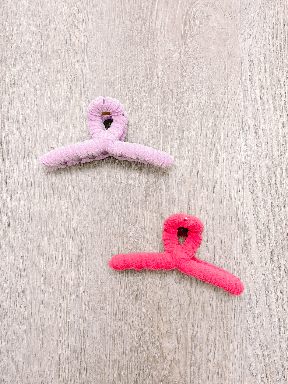 Fuzzy claw clips, pink and coral, soft velvet texture.
