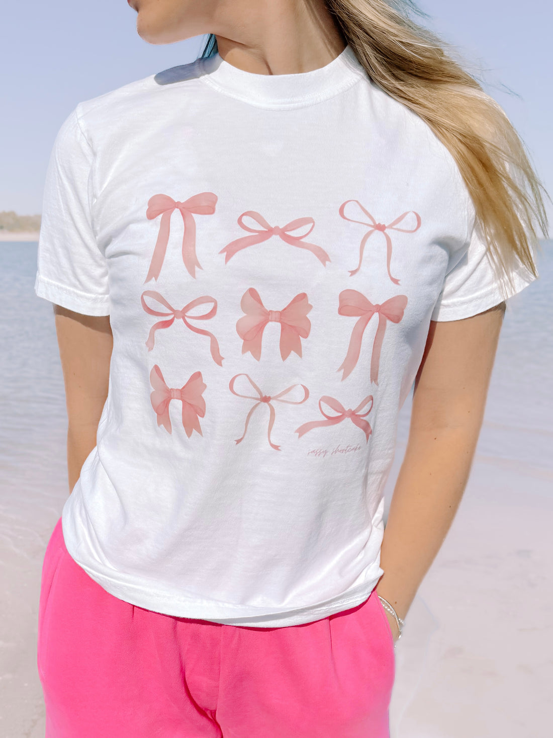 White On Bow Nine tee with blush pink bows graphic
