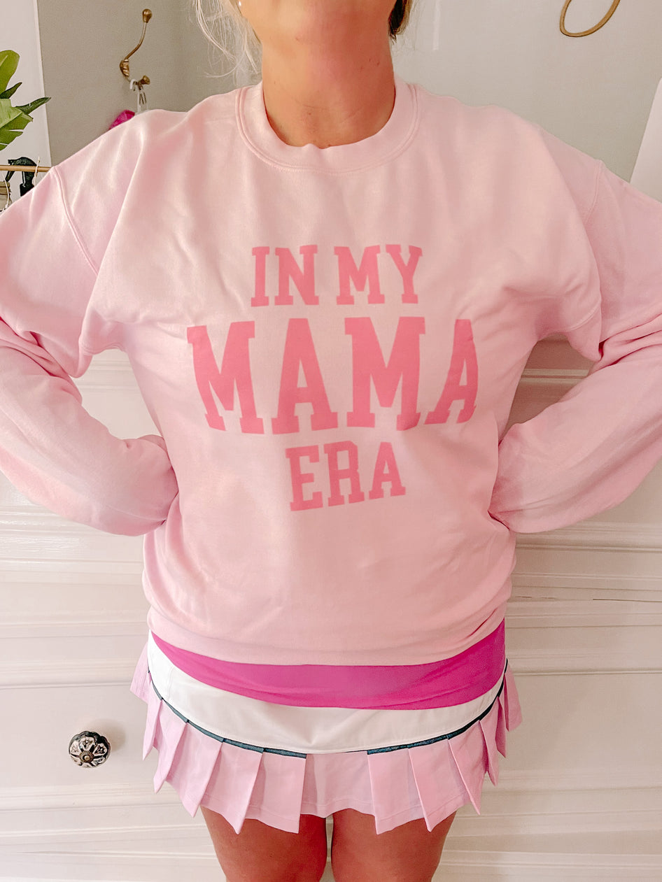 Pink crewneck sweatshirt with "In My Mama Era" graphic.
