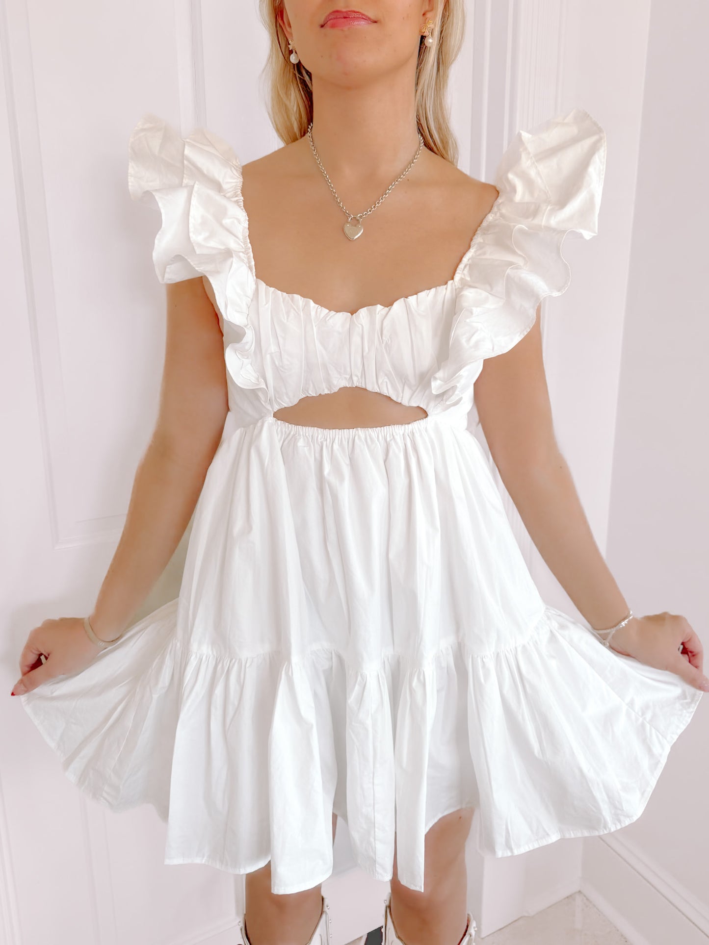 White Brielle Ruffle mini dress with tiered ruffle skirt and cutout detail.
