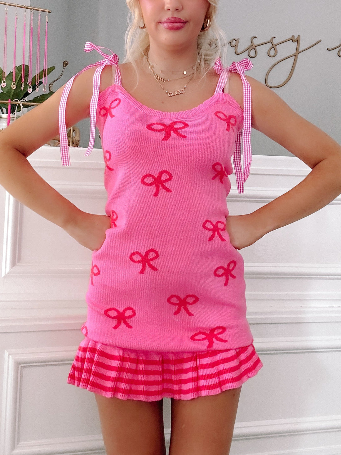 Bailey Bow Dress by Sassy Shortcake – close-up of hot pink knit fabric, gingham straps, and ruffle hem detail