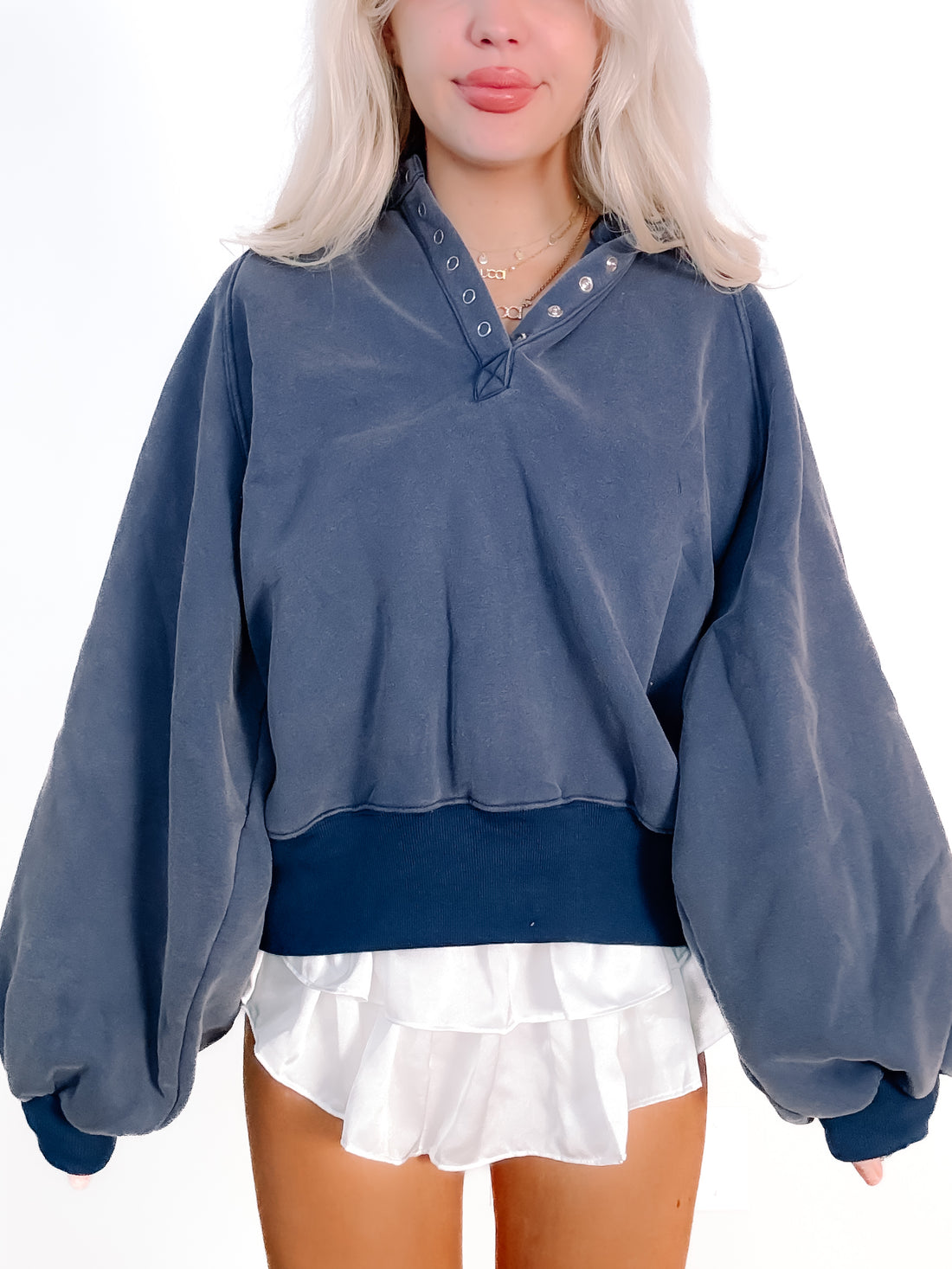 Navy blue Brynn pullover top with balloon sleeves and buttoned henley neckline.
