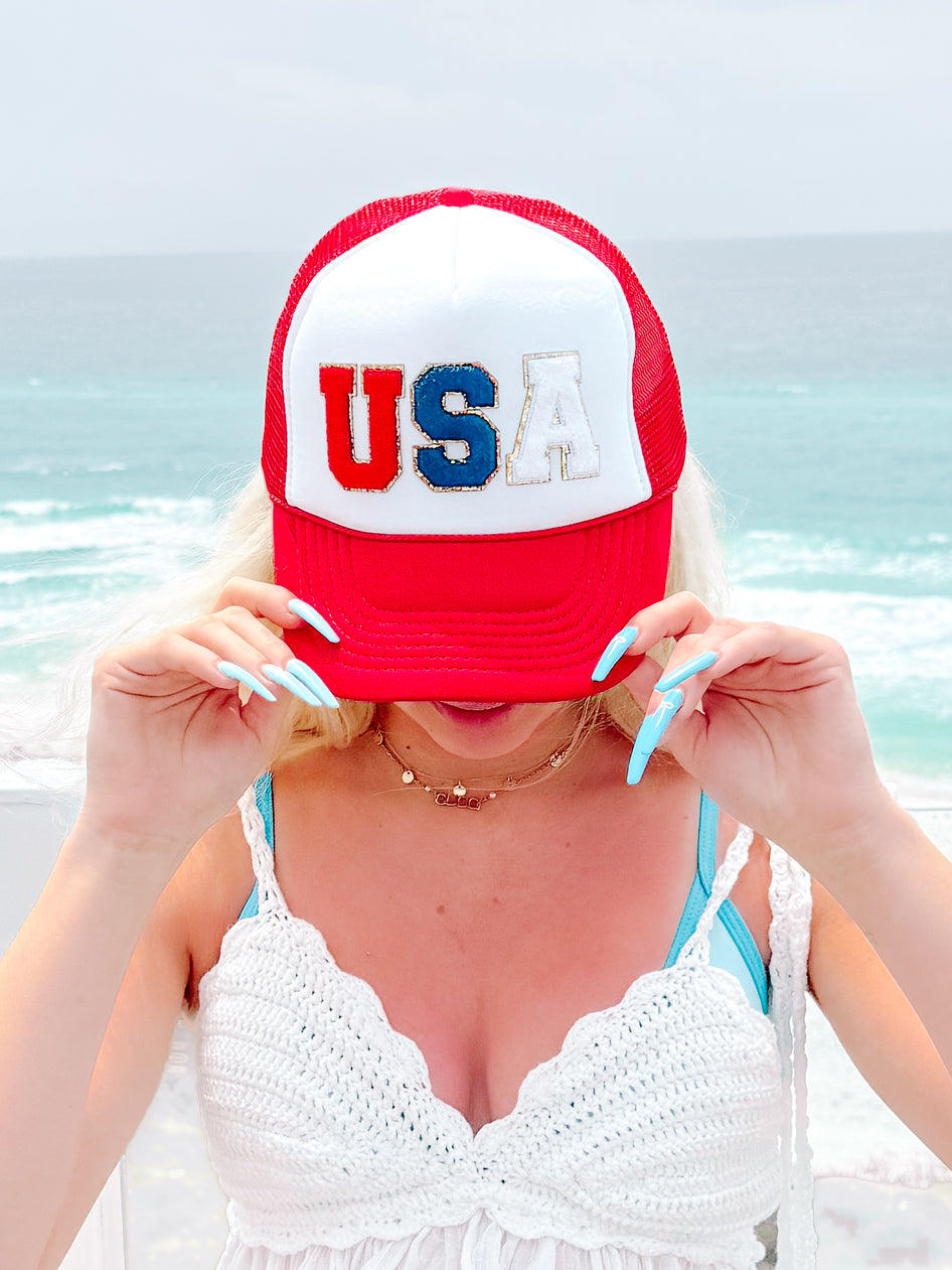 Red USA trucker hat with white and blue lettering
