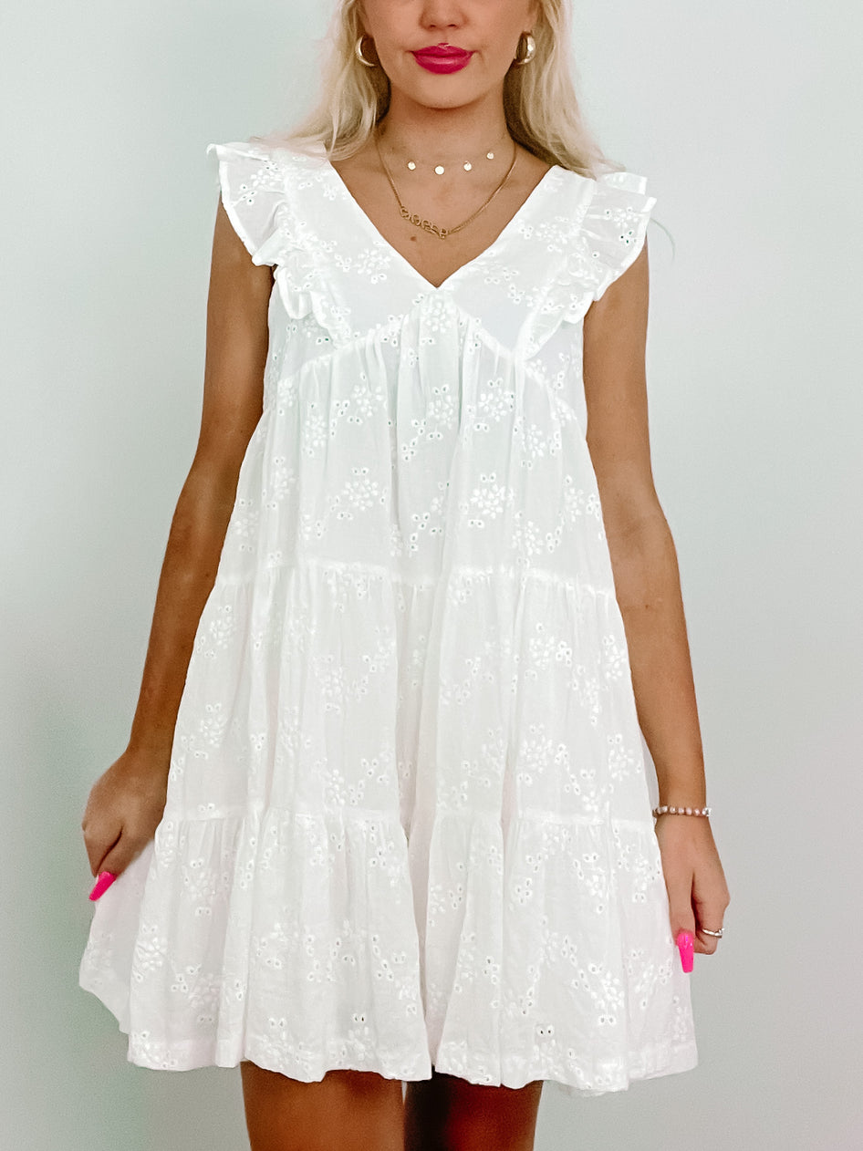 White Eyelet Island Dress:  Tiered mini dress with eyelet embroidery and ruffle details.
