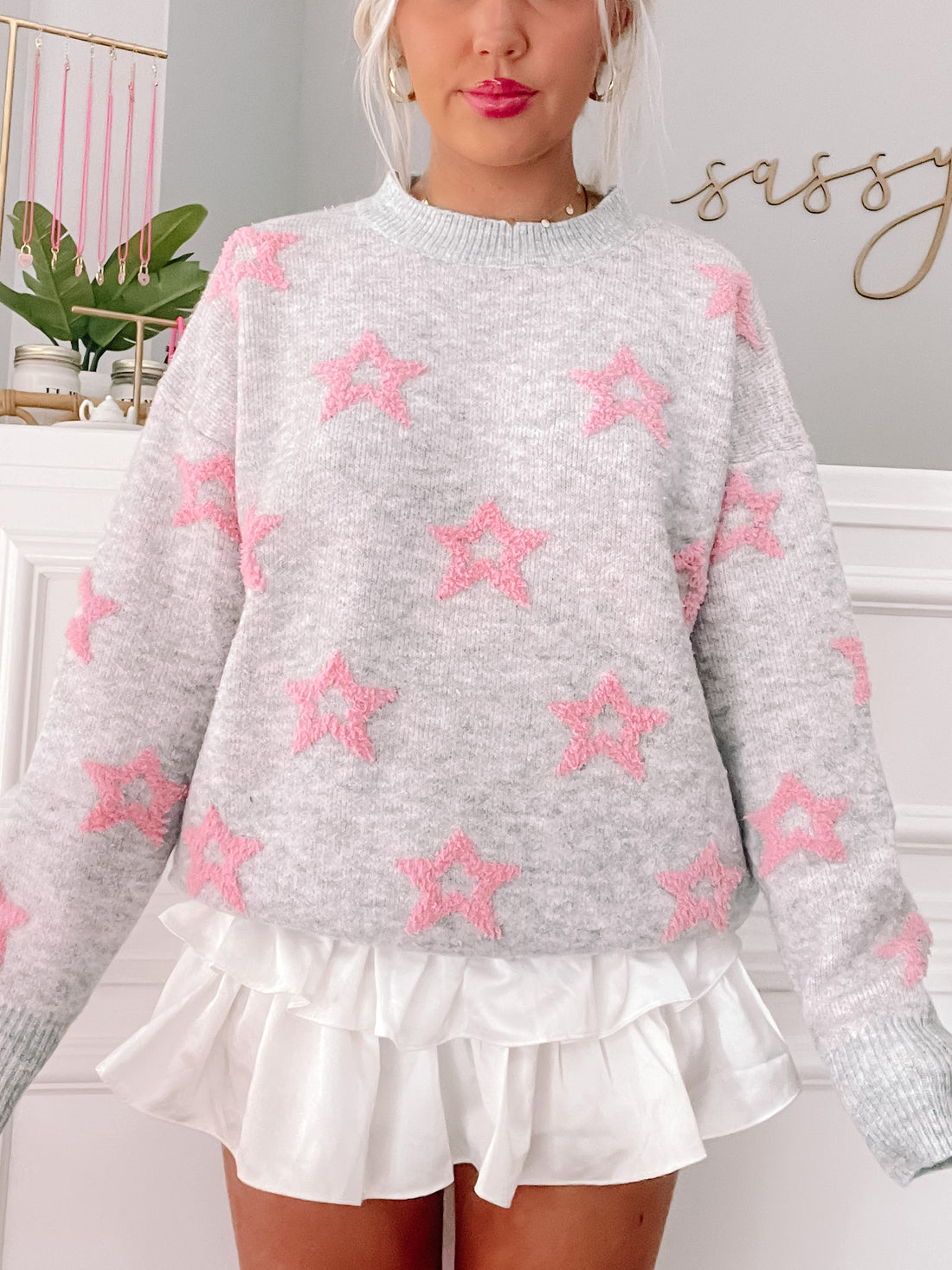 Gray sweater with pink star details;  Rewrite the Stars design.
