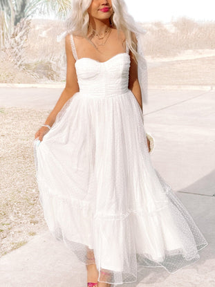 White polka dot tulle midi dress; Sweet as Sugar dress features a sweetheart neckline and tiered skirt.
