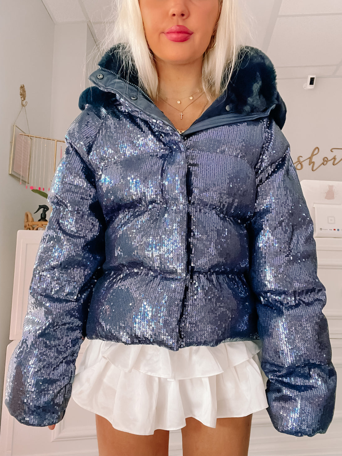 Sequin puffer jacket with faux fur trim, shown on model.
