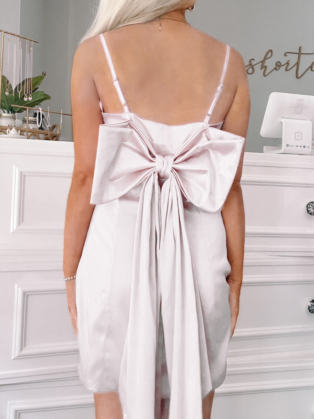 Malibow Barbie Dress in white satin, featuring a large back bow detail.
