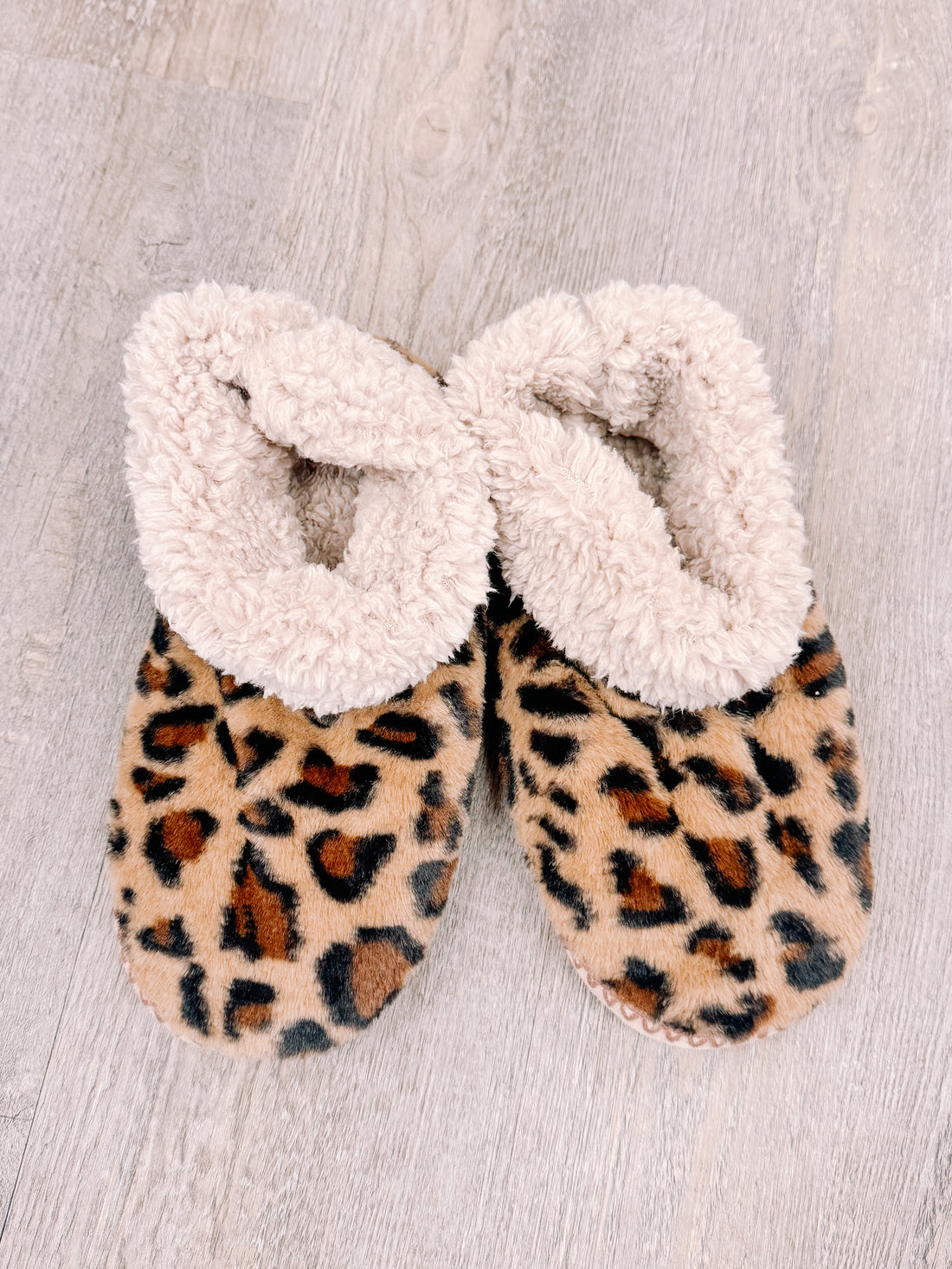 PFS Booties #1: Cozy leopard print slippers with fluffy cream lining for ultimate comfort.
