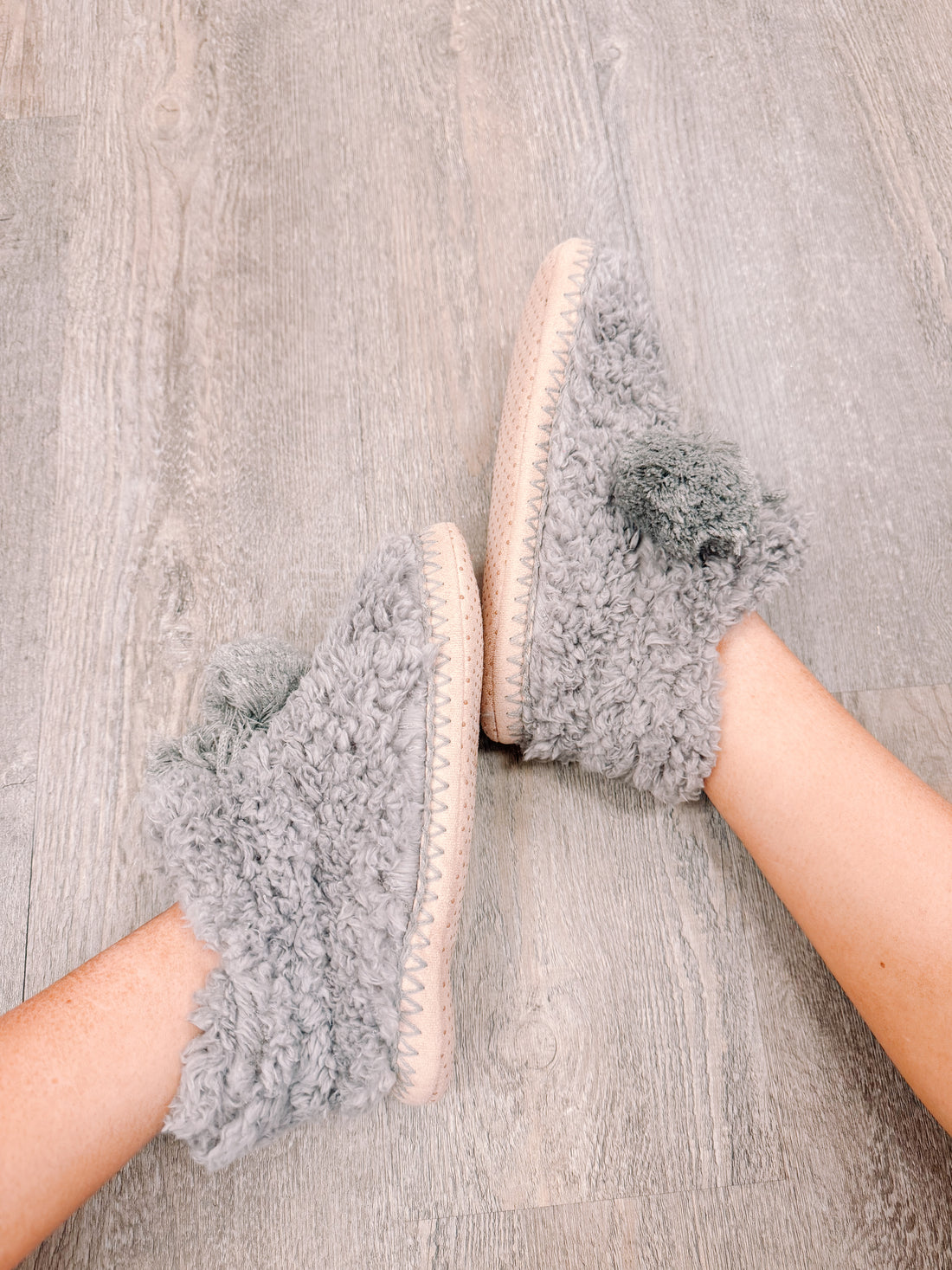 Cozy gray PFS Booties #2: soft, fluffy slippers with pom-poms, perfect for relaxing at home.
