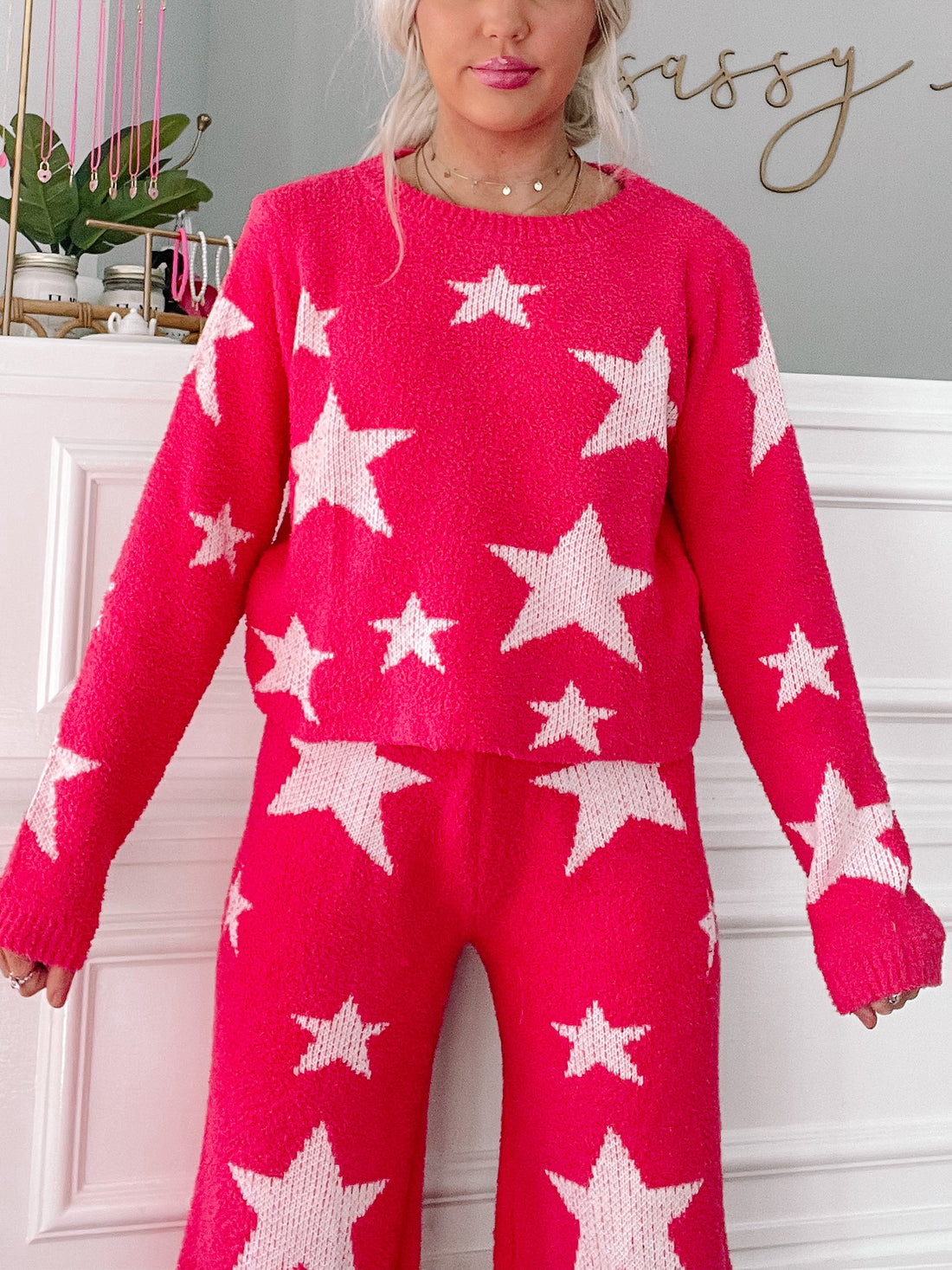 Hot pink sweater and pants set; cozy knit fabric with white star pattern.
