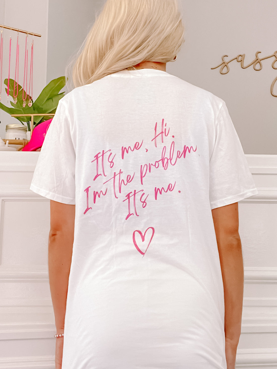 White "I'm the Problem" tee with pink lettering and heart graphic.
