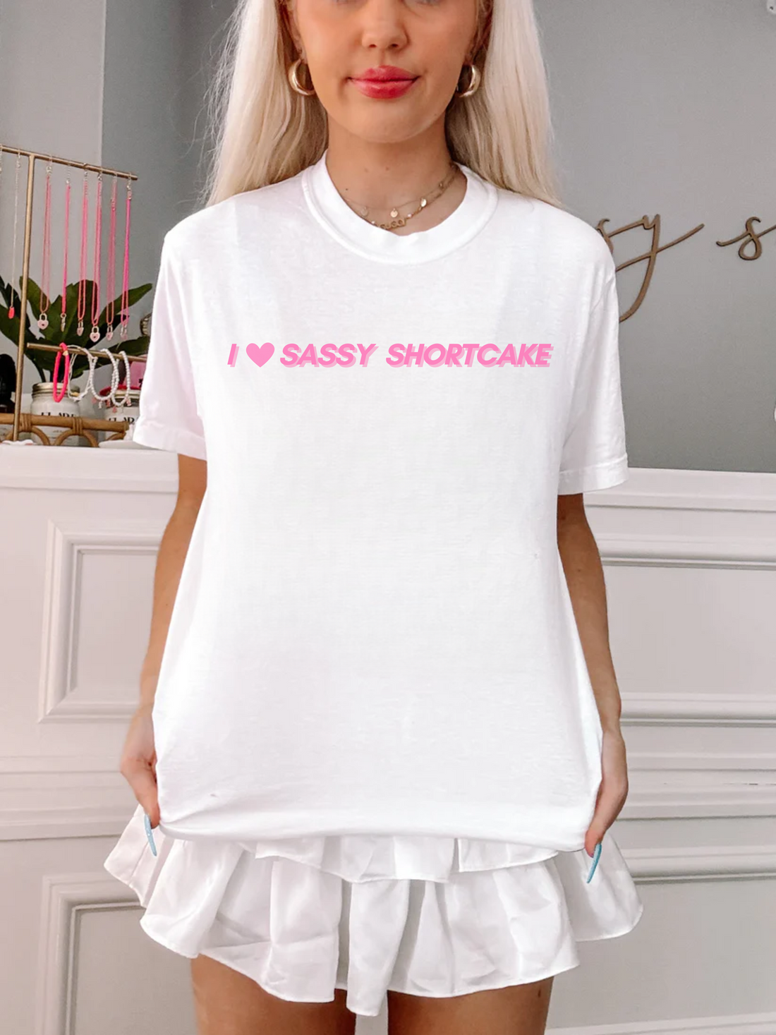 White Sassy Shortcake tee styled on model, bold heart text design in focus.
