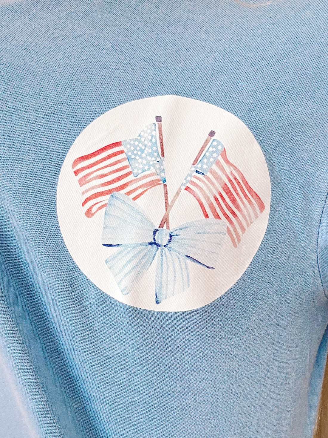 Close-up of bold graphic text and relaxed neckline on blue Sassy Shortcake tee.