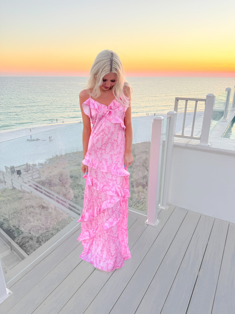 Pink tiered maxi dress with ruffled straps, ocean sunset backdrop
