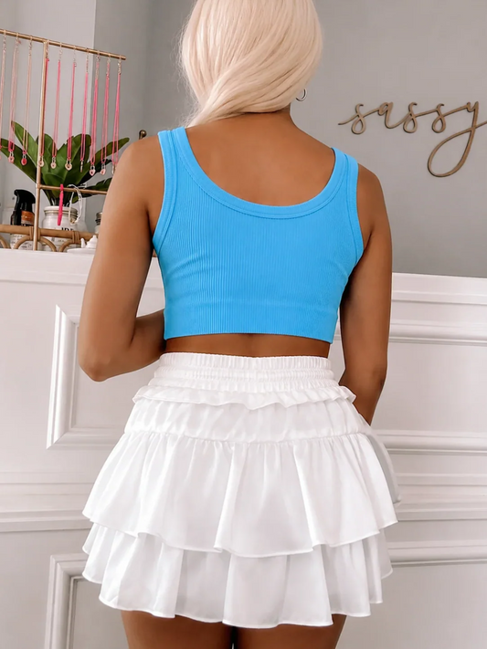 Blue Ribbed On The Way Top from Sassy Shortcake paired with a white skirt, showcasing the soft ribbed texture and sporty everyday style.