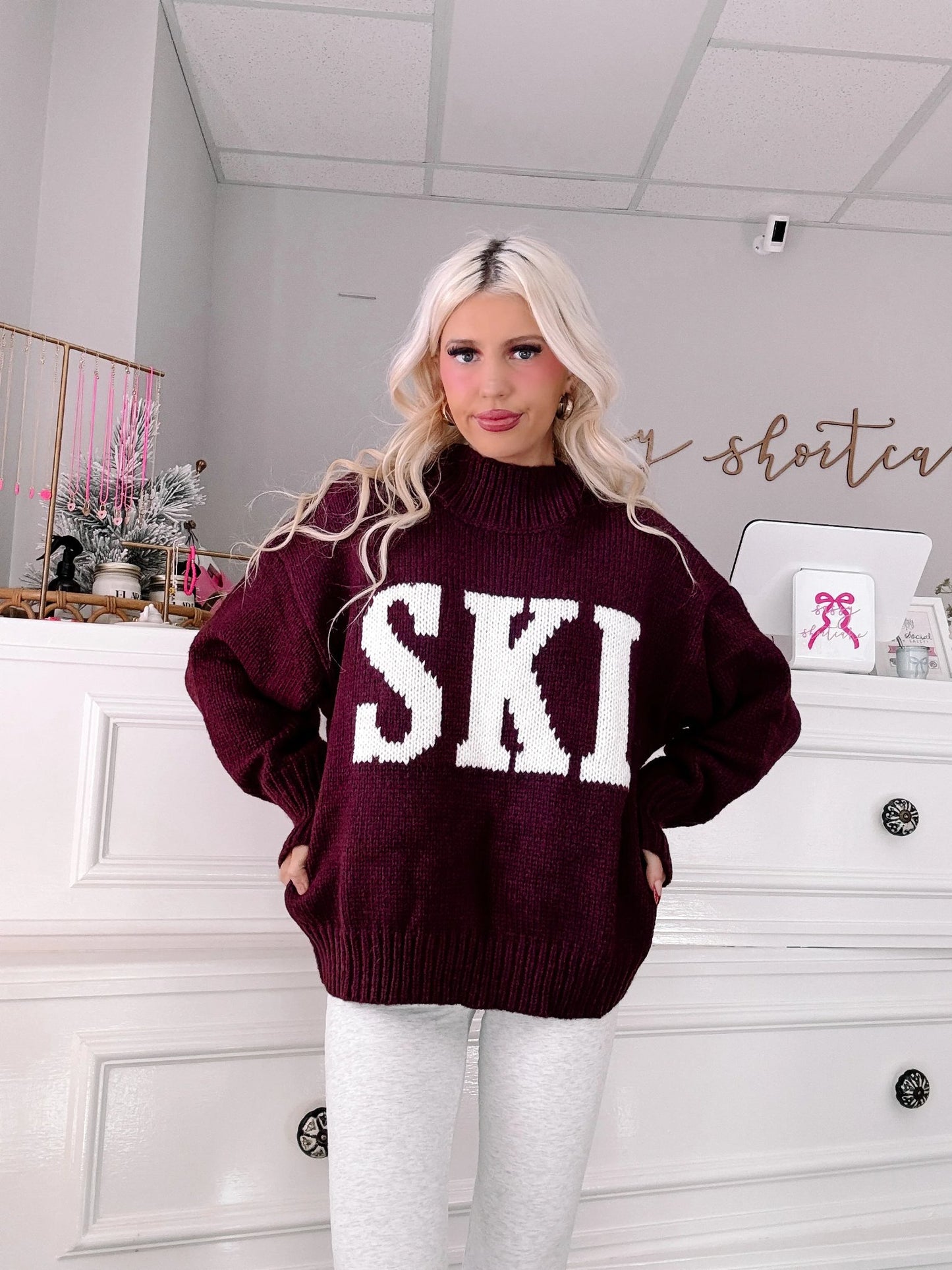 Après Ski Sweater - Sassy Shortcake - burgundy SKI sweater front view hands in pockets