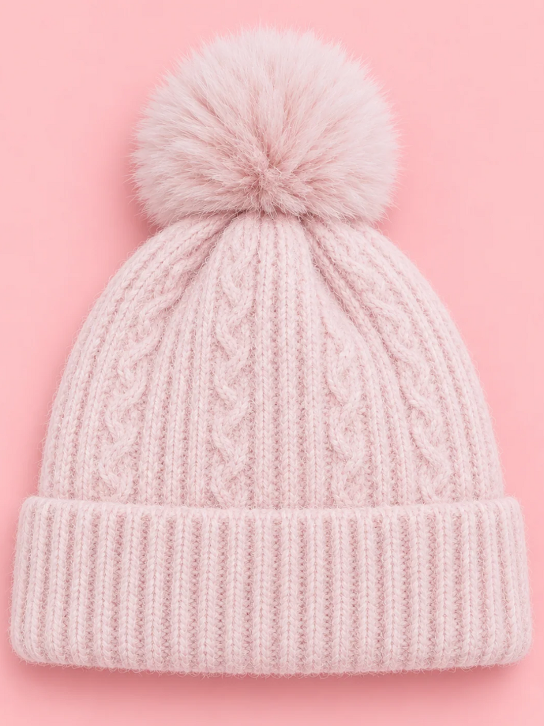 Snow Day Pom Beanie in Pink from Sassy Shortcake, a light pink cable knit beanie with a ribbed fold-over cuff and a fluffy pink pom pom.